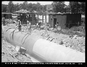 Distribution Department, Weston Aqueduct Supply Lines, Section 7, cleaning 80-inch steel pipe with sand blast, Newton, Mass., Jul. 25, 1911