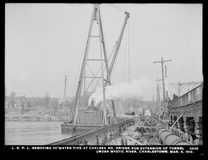 Distribution Department, Low Service Pipe Lines, removing 30-inch water pipe at Chelsea North Bridge, for extension of tunnel under Mystic River, Charlestown, Mass., Mar. 8, 1912