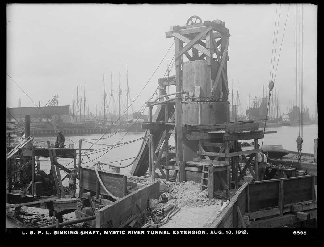 Distribution Department, Low Service Pipe Lines, Mystic River tunnel extension, sinking shaft; see vessels in background, Charlestown, Mass., Aug. 10, 1912