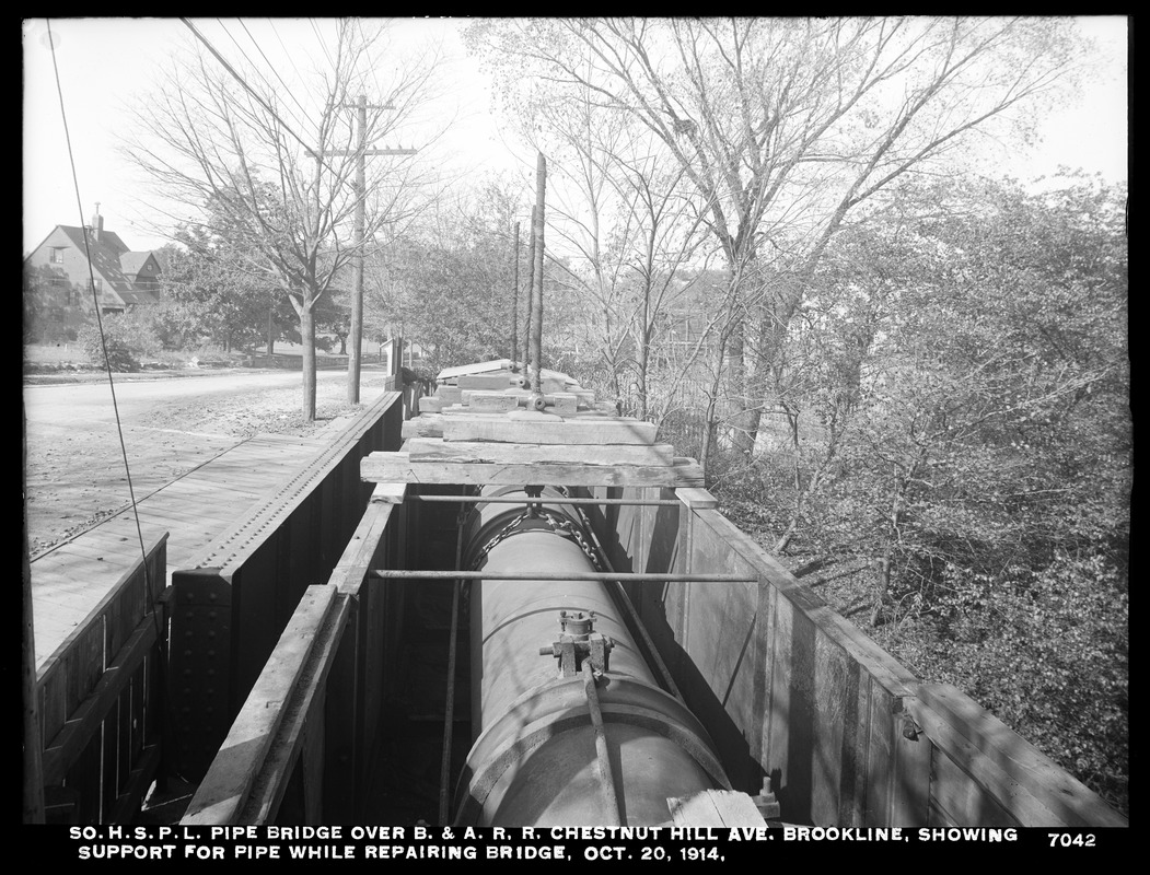 Distribution Department, Southern High Service Pipe Lines, pipe bridge over Boston & Albany Railroad, Chestnut Hill Avenue, showing support for pipe while repairing bridge, Brookline, Mass., Oct. 20, 1914