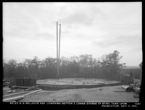 Distribution Department, Southern Extra High Service Bellevue Reservoir, lowering bottom and lower course of steel tank upon foundation, Bellevue Hill, West Roxbury, Mass., Nov. 9, 1914
