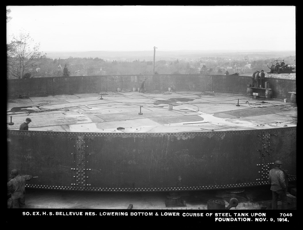 Distribution Department, Southern Extra High Service Bellevue Reservoir, lowering bottom and lower course of steel tank upon foundation, Bellevue Hill, West Roxbury, Mass., Nov. 9, 1914