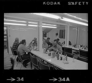 Men sit in a cafeteria, North Slope camp, Anchorage, Alaska