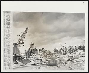 Picking Up the Pieces-- Volunteers and residents search the wreckage at Larose, La. as a massive cleanup begins in the wake of Hurricane Hilda. A tornado struck out of the storm and flattened most of the fishing village. Twenty-one persons were killed and more than 150 were injured.