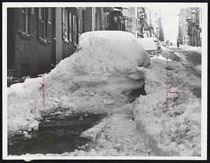 On Pinckney Street this piled drift really has a parked automobile somewhere inside.