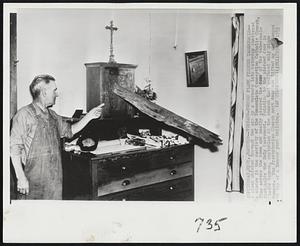 Tornado-Tossed Plank Pierces Tabernacle-- A plank whisked through the air by a tornado late Saturday shattered a window in the sacristy of the Immaculate Conception Catholic Church, flew across the room and neatly pierced the door of the tabernacle that holds the Holy Sacrament. Pointing to the pierced door is Claude Gammon, custodian at the church that suffered only minor damage. The Presbyterian Church next door was lifted up and dumped on top of a lumber yard building.