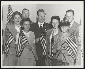 Boston's New Citizens - New Citizens of many nationalities are shown receiving American flags from Mayor Kerrigan today after they registered for voting rights at the offices of election commissioner and registrar of voters. Left to right: Clara Stern, German; Rabbi Henry Fish, Irma M. Ellenberg, and Mr. and Mrs. Arnold Rosenkranz, newlyweds, Austrian, and Mrs. Fannie Gordon, Russian.