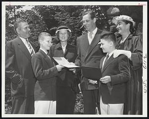 Proud Parents – Secretary of Labor and Mrs. Maurice J. Tobin, center, together with Mr. and Mrs. Charles Kurtzman, Brookline, look over their sons’ diplomas following graduation exercises at Walnut Park Country Day School, Newton. Both lads, Kenneth Kurtzman (left) and Maurice, Jr. (right), were among those graduating.