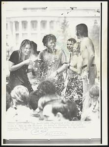 Cooling It--Liquid flies as young people clown a bit on the Ellipse in today's 88-degree Washington sunshine. The White House is in the background.