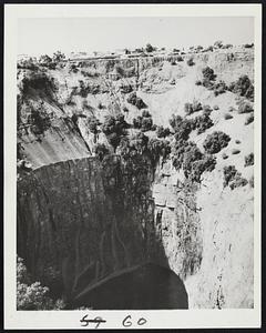 'The Big Hole'-From this "big hole" in Kimberley, South Africa, millions of dollars worth of diamonds have been mined. The immense excavation, located in the center of town, has a perimeter of one mile. From the time of its discovery in 1871, until it was abandoned in 1919, three tons of diamond valued at $500,000,000 were taken out.