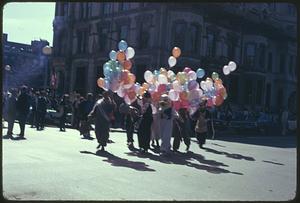 People holding balloons, some wearing costumes, Boston Columbus Day Parade 1973