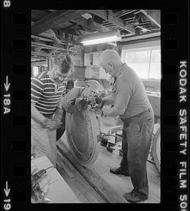 Men working in Pert Lowell's boat shop