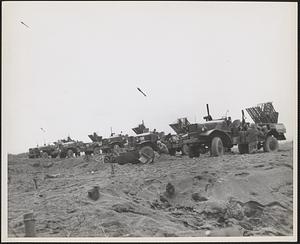 Hit and run rocket fire was the order when these Marines of the Fifth Division loosed a barrage at the enemy on Iwo Jima