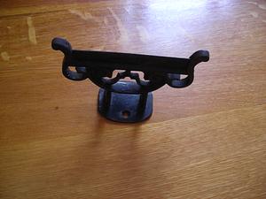 Dark metal object with scrolled detail