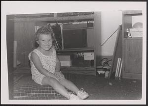 Girl sitting on a pillow