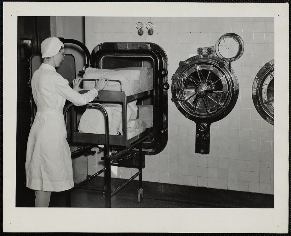 Faulkner Hospital operating room worker loading rectangular sterilizer