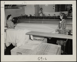 Pressing linens at the Faulkner Hospital laundry