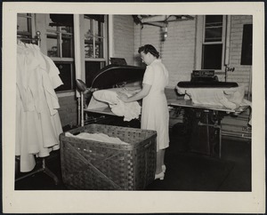 Pressing uniforms at the Faulkner Hospital laundry