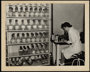Faulkner Hospital laboratory technician using a microscope