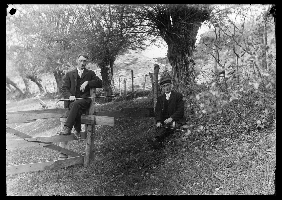 2 men from pasture fence