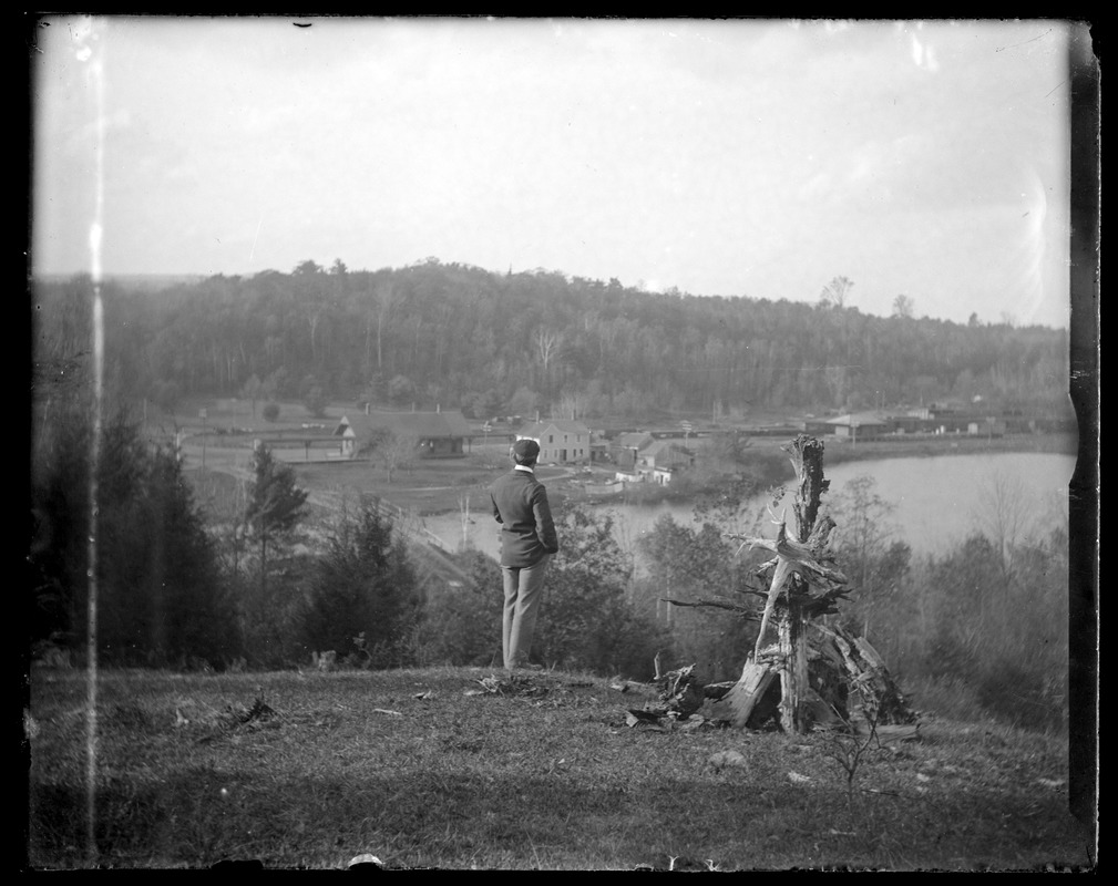 Augustus Martin standing on hilltop overlooking Woods Pond