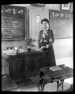 Young school mistress at her desk