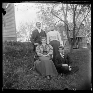 Four young people in front of Crystal St. house