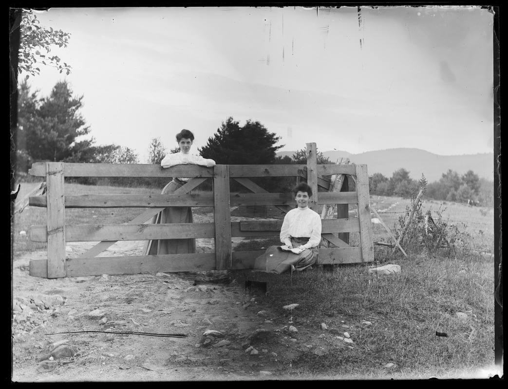 2 women by pasture gate