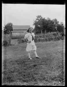 Young girl - garden & barn in background