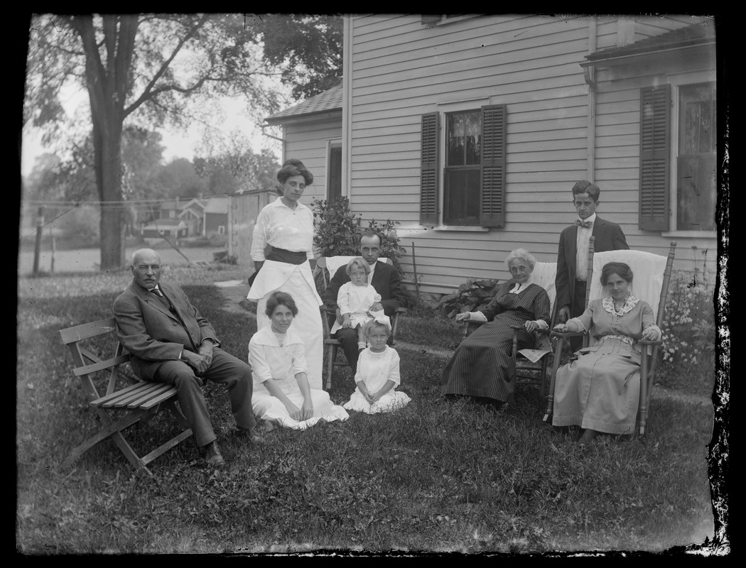 Bull[?] family portrait in front of house