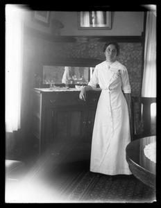 Woman standing by dining-room sideboard