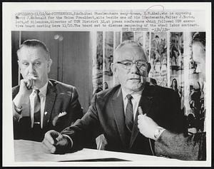 United Steelworkers secy-treas, I.W. Abel, who is opposing David J. McDonald for the Union President, sits beside one of his lieutenants, Walter J. Burke, left, of Milwaukee, director of USW District 32, at press conference which followed USW executive board meeting here 11/10. The board met to discuss reopening of the steel labor contract.