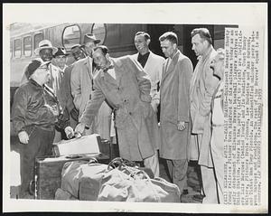 Milwaukee – Early Braves – Equipment manager Shorty Young relieves Pitcher Vern Bickford of his suitcase today as an early detachment of Milwaukee Braves baseball players arrives at Union Station. Others in the party (left to right) are Outfielders Luis Marquiz (behind Young) and Jim Pendleton, Coach Bucky Walters, Pitchers Ernie Johnson, Lew Burdette and Max Surkont, and Ticket Man Tony Piccolo. An unidentified onlooker peers between Marquez and Pendleton. The rest of the Braves’ squad is due tomorrow.