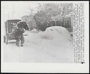 Hazleton, Pa. - Dobbin Gives Horse Laugh - With mouth wide open, a milk wagon horse appears to be laughing at snowbound auto as Penna's worst snowstorm in years snarled traffic and made transportation by "horseless carriage" a bit difficult. Snow up to 12 inches was dumped on the Keystone State.