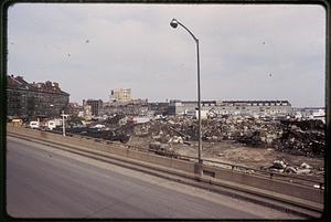 View from the elevated highway, debris in the foreground, piers in the background, current site of Christopher Columbus Waterfront Park, Boston