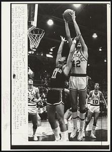 He's Got The Reach -- Bob Kissane (42) of Holy Cross goes high in the air to haul down rebound against Mississippi in Marshall University Invitational. Ole Miss' Cecil Jones has position, but not the height. Mississippi won, 99-93.