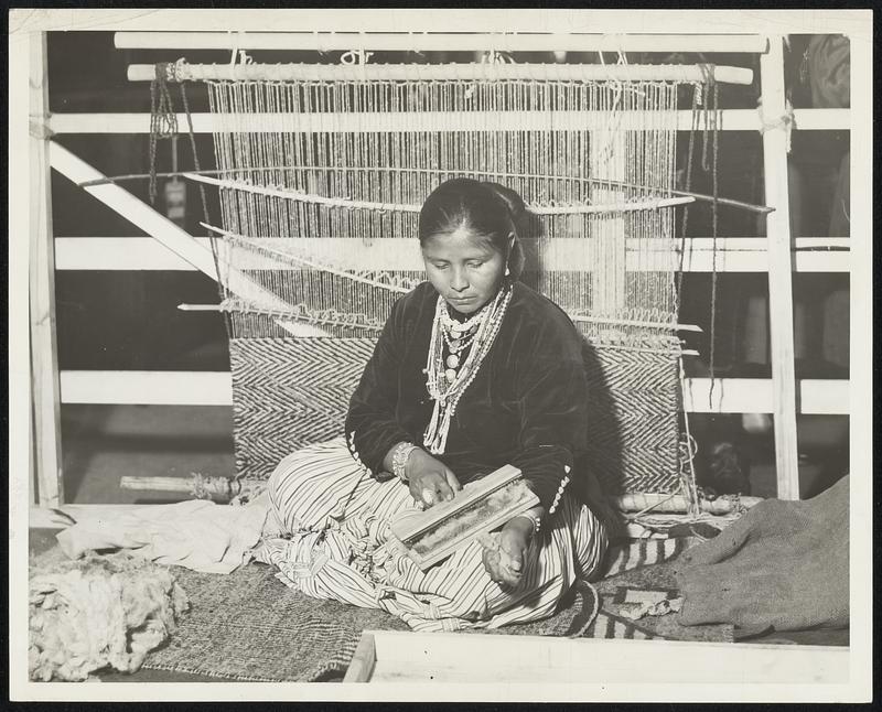 This Indian woman is one of the skilled Navajo rug makers now