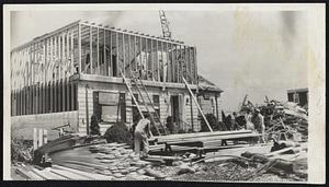 Reconstruction in Worcester-Three days after tornado destroyed two-thirds of this cottage, contractors pushed aside the rubble and made fast progress in rebuilding.