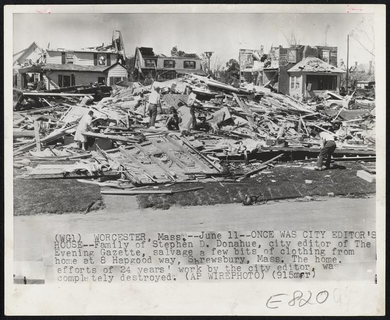 Once Was City Editor's House--Family of Stephen D. Donahue, city editor of The Evening Gazette, salvage a few bits of clothing from home at 8 Hapgood way, Shrewsbury, Mass. The home, efforts of 24 years' work by the city editor, was completely destroyed.