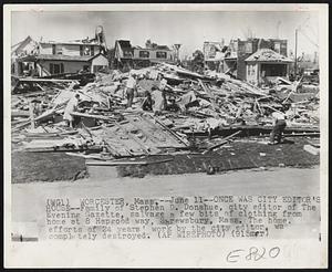 Once Was City Editor's House--Family of Stephen D. Donahue, city editor of The Evening Gazette, salvage a few bits of clothing from home at 8 Hapgood way, Shrewsbury, Mass. The home, efforts of 24 years' work by the city editor, was completely destroyed.