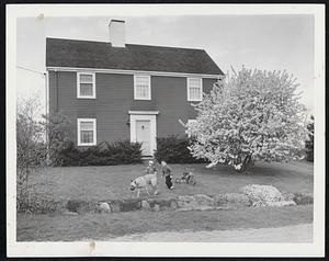 Winchester Spring Scene at the home of Harry W. Murdock, 4 Robin Hood road, with the Oriental crab tree in full bloom and the rock garden beginning to show blossoms. In the yard are Ted, 5, Nancy, 18 months, and Dunny, the dog.