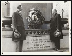 Mayor Mansfield opening the Lincoln birthday observances in Boston early today by placing a wreath at the foot of the Lincoln emancipation statue in Park square. Albert G. Wolffe, president of the Equal Rights League, is at his left.