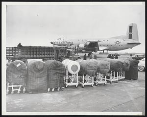 Iron lungs await loading a board a U.S. Air Force Globemaster at Logan International Airport, Boston today (March 6) for flight to Buenos Aires to aid the polio-stricken capital of Argentina where upwards of 800 cases of the disease have been reported since Jan.21. The lungs are being sent by the U.S. Government, through the States Department, the International Cooperation Administration, and the U.S. Air Force with the cooperation of the Pan American Sanity Bureau and the National Foundation for Infantile Paralysis.
