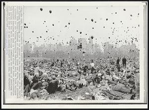 Making Their Protest Horizontally--Supporters of the Vietnam Moratorium lie on the ground in the Sheep Meadow in New York’s Central Park Friday. Hundreds of balloons, black and white, float overhead. A spokesman for the Vietnam Moratorium Committee said the black balloons represented Americans who died in Vietnam since the Nixon administration took office and the white balloons symbolize the number of Americans who will die if the war is not quickly brought to an end.