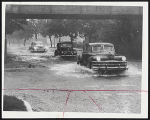 Underpasses Were Flooded by the driving rain throughout Greater Boston. Visibility was near zero for the motorists who ventured into the storm, and most of them kept their headlights on, as did these cars.