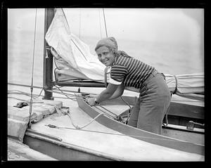 Unidentified woman working the rigging of a boat