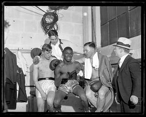 A group of boxers including one playing the ukelele