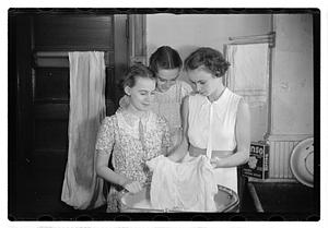 Women doing laundry with a washing machine