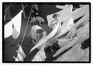 Women hanging laundry on clotheslines