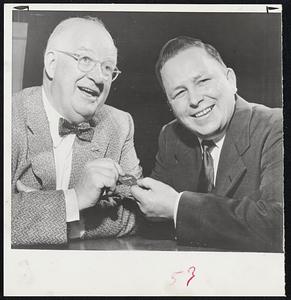 Surprise New Detroit Hockey Coach He is Jim Skinner (right) being presented a No. 7 check by Gen. Mgr. Jack Adams The seven signifies Detroit's hopes for its seventh succesive championship. Skinner is 203 pounds age 37 a ten-year veteran in the Detroit farm system.